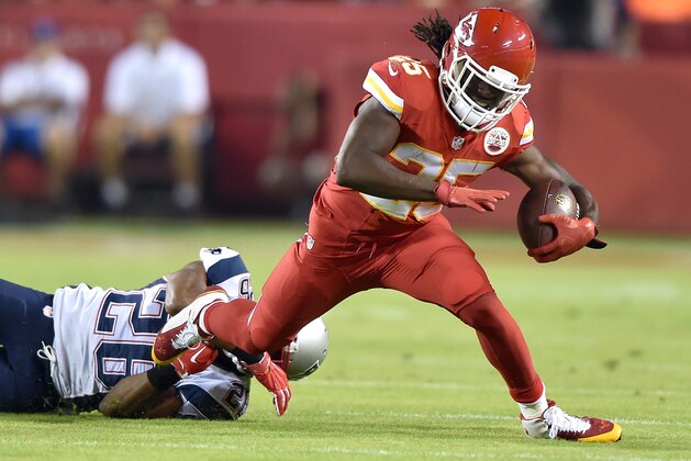 KANSAS CITY, MO - SEPTEMBER 29:  Jamaal Charles #25 of the Kansas City Chiefs is tripped up by  Logan Ryan #26 of the New England Patriots during the game at Arrowhead Stadium on September 29, 2014 in Kansas City, Missouri.  (Photo by Peter Aiken/Getty Images)