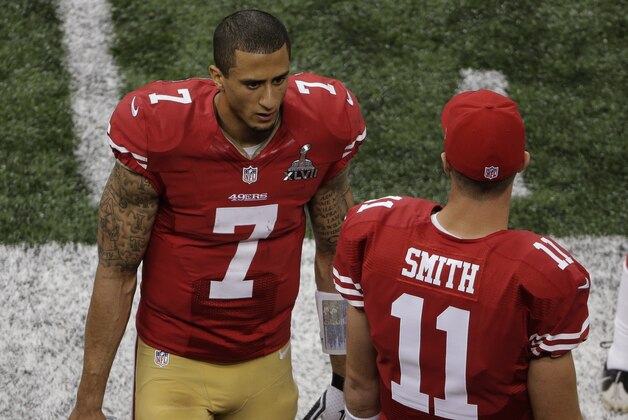 San Francisco 49ers quarterbacks Colin Kaepernick (7) and Alex Smith (11) talk on the sideline late in the fourth quarter of the NFL Super Bowl XLVII football game against the Baltimore Ravens, Sunday, Feb. 3, 2013, in New Orleans. (AP Photo/Charlie Riedel)
