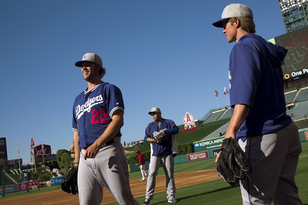 Los Angeles Dodgers pitchers Clayton Kershaw, Hyun-Jin Ryu, of South Korea, and Zack Greinke stand on the field during practice for the team's baseball game against the Los Angeles Angels on Wednesday, Aug. 6, 2014, in Anaheim, Calif. (AP Photo/Jae C. Hong)