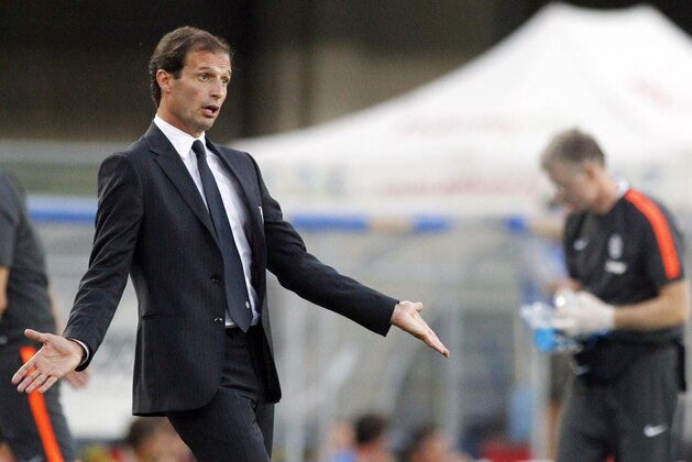 Juventus' coach Massimiliano Allegri gestures during a Serie A soccer match against Chievo Verona at Bentegodi's stadium in Verona, Italy, Saturday, Aug. 30, 2014. (AP Photo/Felice Calabro')