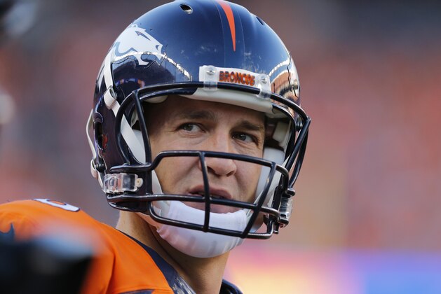 Denver Broncos quarterback Peyton Manning looks to his bench during the first half of an NFL football game against the Indianapolis Colts, Sunday, Sept. 7, 2014, in Denver. (AP Photo/Jack Dempsey)