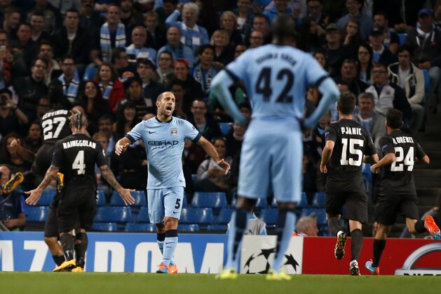 Manchester City's Pablo Zabaleta (5) reacts as Roma players celebrate the goal of Francesco Totti during a Champions League group E soccer match between Manchester City and Roma at the Etihad Stadium, Manchester, England, Tuesday, Sept. 30, 2014. (AP Photo/Jon Super)