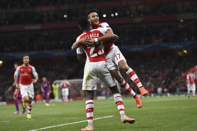 Arsenal's Danny Welbeck , celebrates after scoring against Galatasaray with Arsenal's Alexis Sanchez, right, during the Champions League Group D soccer match between Arsenal  and Galatasaray , at the Emirates Stadium in London, on Wednesday, Oct 1, 2014. (AP Photo/ Tim Ireland)