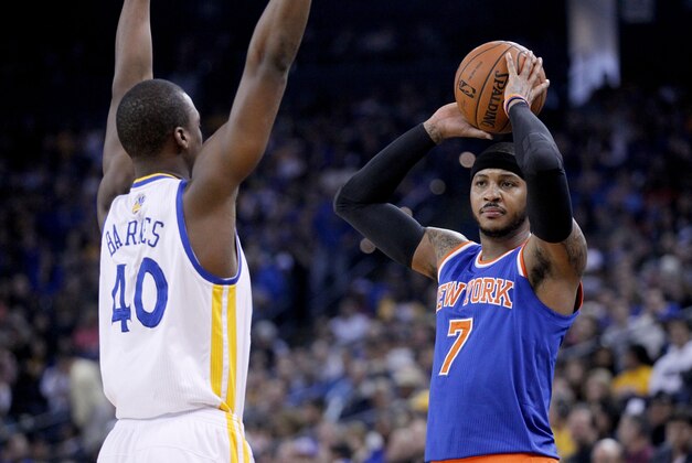 Mar 30, 2014; Oakland, CA, USA; New York Knicks forward Carmelo Anthony (7) holds the ball as Golden State Warriors forward Harrison Barnes (40) defends in the first quarter at Oracle Arena. Mandatory Credit: Cary Edmondson-USA TODAY Sports
