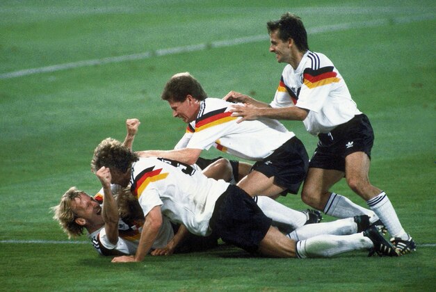 FILE - In this July 8, 1990 file photo, Germany players celebrate after Andreas Brehme, left on ground, scores the winning goal in the World Cup soccer final match against Argentina, in the Olympic Stadium, in Rome, Italy. On Sunday, July 13, 2014, Germany and Argentina will face each other again in the final of the 2014 soccer World Cup.(AP Photo/Carlo Fumagalli, File)