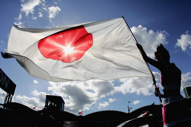 SUZUKA, JAPAN - OCTOBER 08:  A grid girl holds the Japanese flag prior to the start of the Japanese F1 Grand Prix at the Suzuka Circuit on October 8, 2006 in Suzuka, Japan.  (Photo by Clive Rose/Getty Images)