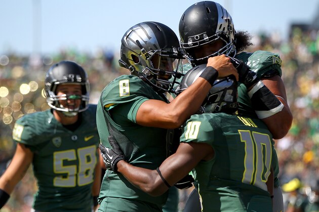EUGENE, OR - SEPTEMBER 13:  Quarterback Marcus Mariota #8 of the Oregon Ducks celebrates a touchdown pass to Johnathan Loyd #10 against the Wyoming Cowboys at Autzen Stadium on September 13, 2014  in Eugene, Oregon.  (Photo by Jonathan Ferrey/Getty Images)