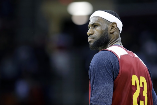 Cleveland Cavaliers' LeBron James stands on the court during an NBA scrimmage basketball game Wednesday, Oct. 1, 2014, in Cleveland. (AP Photo/Tony Dejak)