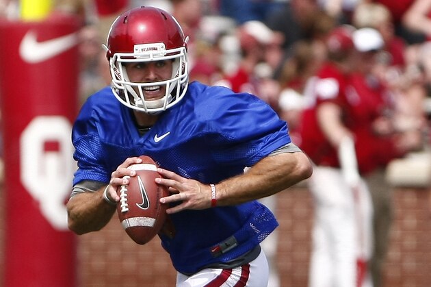 Oklahoma quarterback Trevor Knight (9) looks to pass  during their annual spring NCAA college football game in Norman, Okla., Saturday, April 12, 2014. (AP Photo/Alonzo Adams)