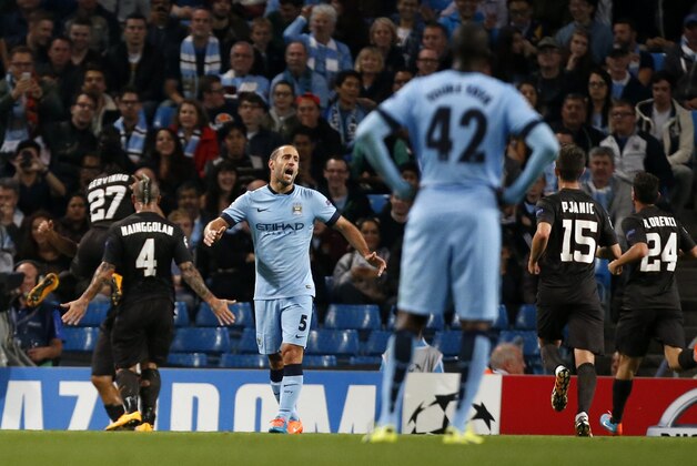 Manchester City's Pablo Zabaleta (5) reacts as Roma players celebrate the goal of Francesco Totti during a Champions League group E soccer match between Manchester City and Roma at the Etihad Stadium, Manchester, England, Tuesday, Sept. 30, 2014. (AP Photo/Jon Super)