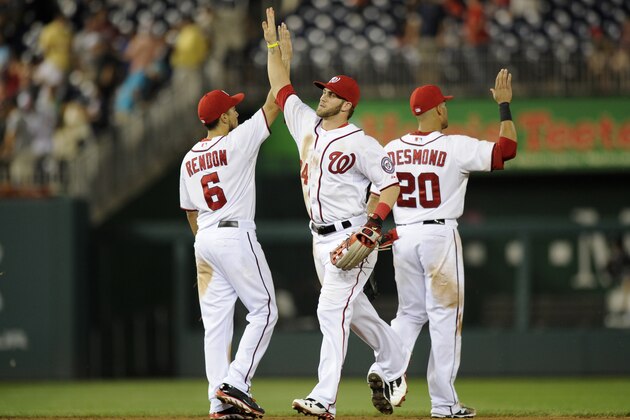 Washington Nationals' Bryce Harper, center, celebrates 2-1 win over the Miami Marlins with Ian Desmond (20) and Anthony Rendon (6) in a baseball game, Tuesday, Aug. 27, 2013, in Washington. The Nationals won 2-1. (AP Photo/Nick Wass)