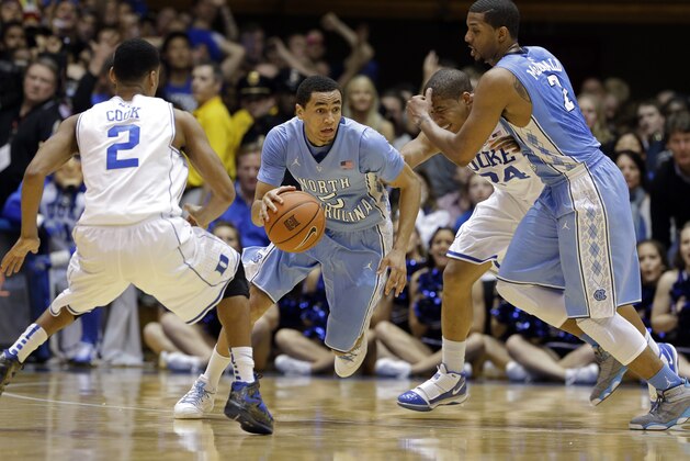 Duke's Quinn Cook (2) and Andre Dawkins (34) defend as North Carolina's Marcus Paige (5) drives while Leslie McDonald, right, blocks during the first half of an NCAA college basketball game in Durham, N.C., Saturday, March 8, 2014. (AP Photo/Gerry Broome)