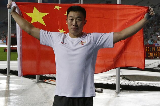 China's Zhao Qinggang celebrates after winning the men's javelin throw final at the 17th Asian Games in Incheon, South Korea, Thursday, Oct. 2, 2014. (AP Photo/Lee Jin-man)