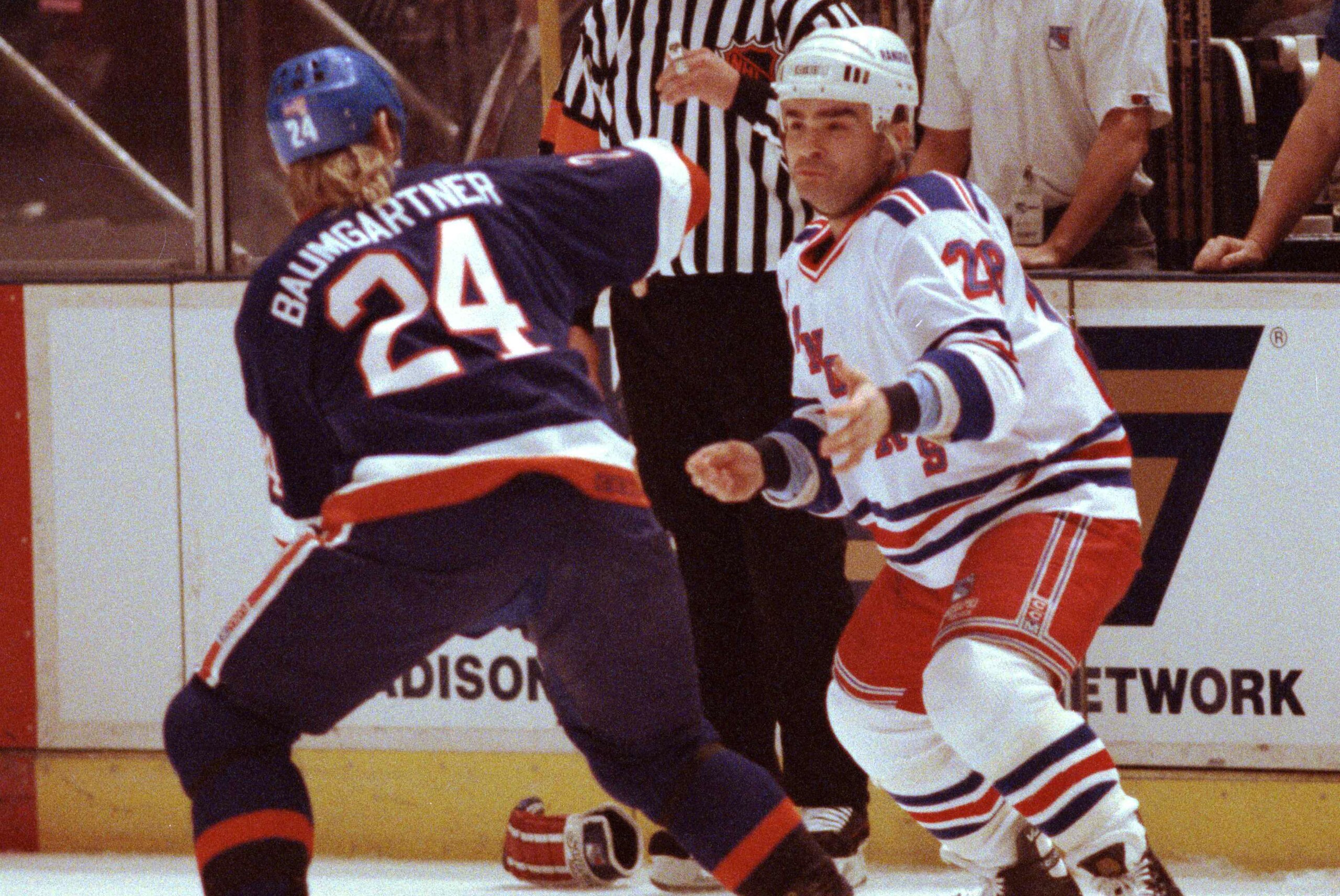 New York Islanders Ken Baumgartner (24) squares off with New York Rangers Tie Domi (28) in first period NHL action at Madison Square Garden in New York, Feb. 6, 1991.  Both players received 5-minute penalties for the fracas.  (AP Photo/Steve Freeman)