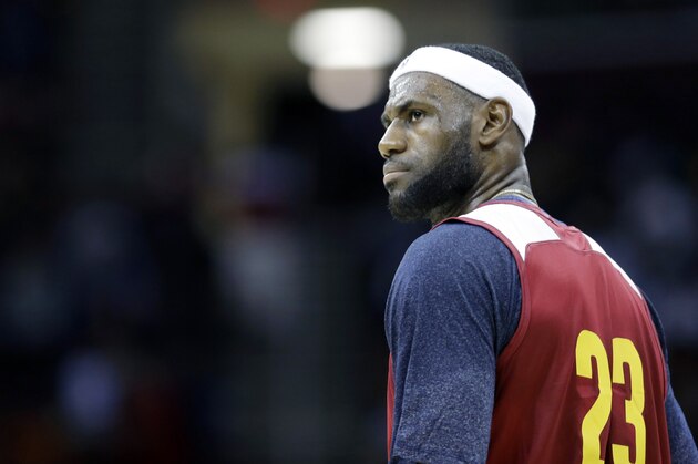 Cleveland Cavaliers' LeBron James stands on the court during an NBA scrimmage basketball game Wednesday, Oct. 1, 2014, in Cleveland. (AP Photo/Tony Dejak)