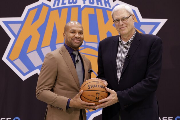 New York Knicks president Phil Jackson, right, poses for a picture with Derek Fisher during a news conference in Tarrytown, N.Y., Tuesday, June 10, 2014. The New York Knicks hired Fisher as their new coach on Tuesday, with Jackson turning to one of his trustiest former players. (AP Photo/Seth Wenig)