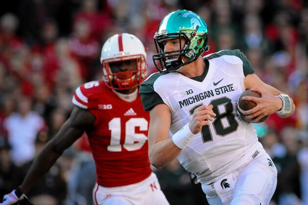 LINCOLN, NE - NOVEMBER 16: Quarterback Connor Cook #18 of the Michigan State Spartans runs from cornerback Stanley Jean-Baptiste #16 of the Nebraska Cornhuskers during their game at Memorial Stadium on November 16, 2013 in Lincoln, Nebraska. (Photo by Eric Francis/Getty Images)
