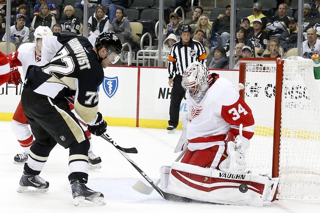 Sep 22, 2014; Pittsburgh, PA, USA; Detroit Red Wings goalie Petr Mrazek (34) makes a save as Pittsburgh Penguins right wing Patric Hornqvist (72) looks for a rebound during the third period at the CONSOL Energy Center. The Red Wings won 2-1. Mandatory Credit: Charles LeClaire-USA TODAY Sports