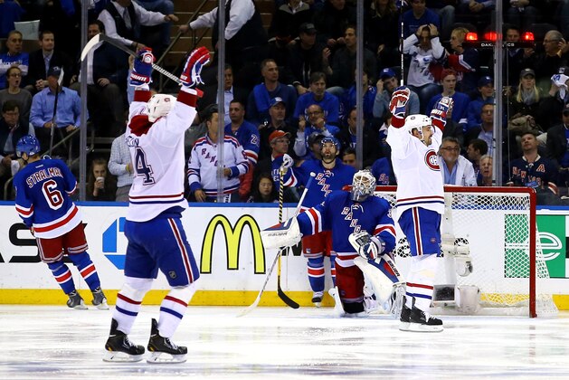 NEW YORK, NY - MAY 22:  Tomas Plekanec #14 of the Montreal Canadiens celebrates Alex Galchenyuk #27 of the Montreal Canadiens game winning overtime goal as Henrik Lundqvist #30 of the New York Rangers looks on in Game Three of the Eastern Conference Final during the 2014 NHL Stanley Cup Playoffs at Madison Square Garden on May 22, 2014 in New York City.Canadiens defeated the Rangers 3-2 in OT.  (Photo by Al Bello/Getty Images)