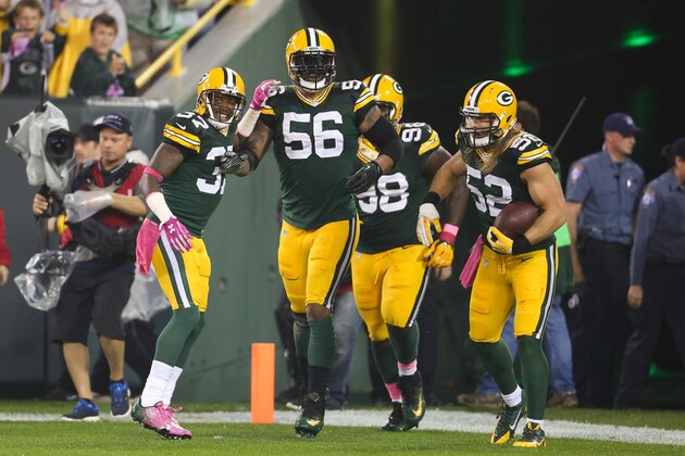 GREEN BAY, WI - OCTOBER 2: Julius Peppers #56 of the Green Bay Packers celebrates with Sam Shields #37, Letroy Guion #98, and Clay Matthews #52 after scoring against the Minnesota Vikings on an interception in the second quarter on October 02, 2014 at Lambeau Field in Green Bay, Wisconsin. (Photo by John Konstantaras/Getty Images)