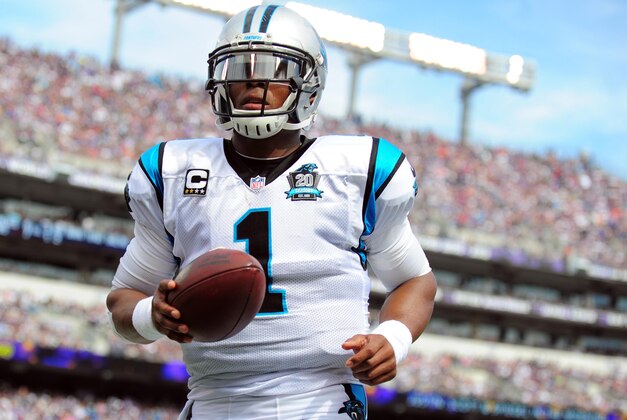 Sep 28, 2014; Baltimore, MD, USA; Carolina Panthers quarterback Cam Newton (1) gives a ball to a fan after a touchdown in the second quarter against the Baltimore Ravens at M&T Bank Stadium. Mandatory Credit: Evan Habeeb-USA TODAY Sports