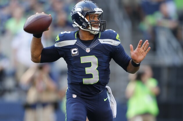 Seattle Seahawks quarterback Russell Wilson in action against the Denver Broncos in the second half of an NFL football game, Sunday, Sept. 21, 2014, in Seattle. (AP Photo/John Froschauer)