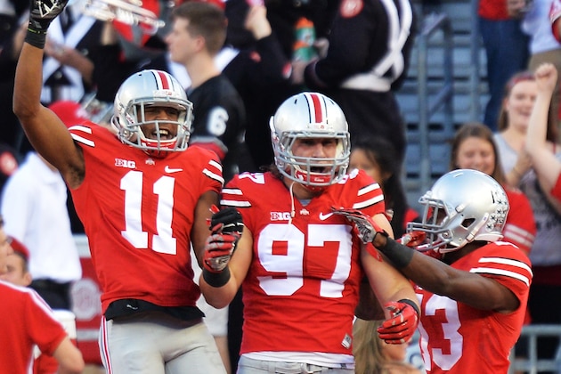 COLUMBUS, OH - SEPTEMBER 27:  Joey Bosa #97 of the Ohio State Buckeyes celebrates after his sack of Gunner Kiel #11 of the Cincinnati Bearcats in the first quarter caused a fumble and safety at Ohio Stadium on September 27, 2014 in Columbus, Ohio. Celebrating with Bosa are Vonn Bell #11 and Eli Apple #13. (Photo by Jamie Sabau/Getty Images)