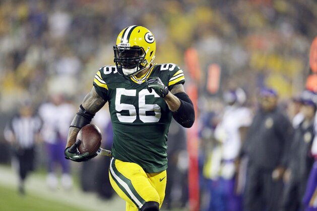 Green Bay Packers' Julius Peppers runs back an interception 49-yards for a touchdown during the first half of an NFL football game against the Minnesota Vikings Thursday, Oct. 2, 2014, in Green Bay, Wis. (AP Photo/Tom Lynn)