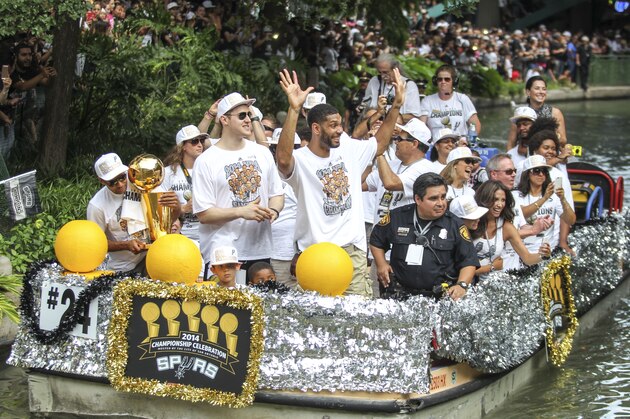 SAN ANTONIO, TX - JUNE 18:  Tim Duncan and Aron Baynes of the San Antonio Spurs participate in a victory parade and celebration with teammates and coaches after winning the 2014 NBA Championship on June 18, 2014 in San Antonio, Texas. NOTE TO USER: User expressly acknowledges and agrees that, by downloading and or using this Photograph, user is consenting to the terms and conditions of the Getty Images License Agreement. Mandatory Copyright Notice: Copyright 2014 NBAE (Photo by Layne Murdoch Jr./NBAE via Getty Images)