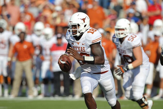 Texas' Tyrone Swoopes runs during an NCAA football game against the Kansas Saturday, Sept. 27, 2014, in Lawrence, Kan. (AP Photo/Ed Zurga)