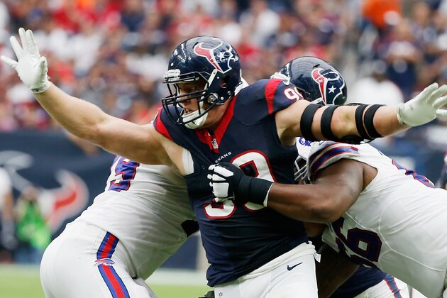 HOUSTON, TX - SEPTEMBER 28:  J.J. Watt #99 of the Houston Texans fisghts off two blockers during the third quarter of their game against the Buffalo Bills at NRG Stadium on September 28, 2014 in Houston, Texas.  (Photo by Scott Halleran/Getty Images)