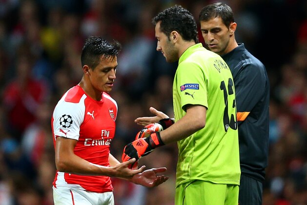 LONDON, ENGLAND - OCTOBER 01:   Alexis Sanchez of Arsenal taps hands with David Ospina as he is substituted following Wojciech Szczesny's red card during the UEFA Champions League group D match between Arsenal FC and Galatasaray AS at Emirates Stadium on October 1, 2014 in London, United Kingdom.  (Photo by Paul Gilham/Getty Images)