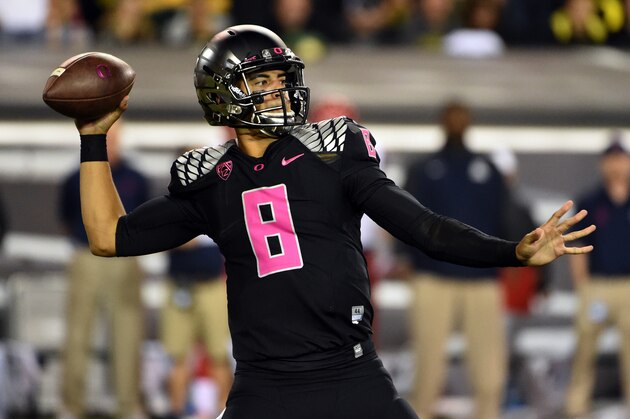 Oregon quarterback Marcus Mariota (8) passes the ball during the first quarter of an NCAA college football game against Arizona at Autzen Stadium on Thursday, Oct. 2, 2014, in Eugene, Ore. (AP Photo/Steve Dykes)