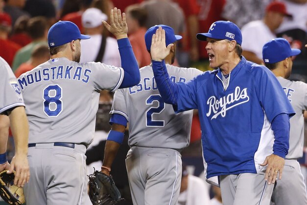 Kansas City Royals manager Ned Yost, right, celebrates with Mike Moustakas after the Royals' 3-2 win over the Los Angeles Angels in 11 innings during Game 1 of baseball's AL Division Series in Anaheim, Calif., Thursday, Oct. 2, 2014. Moustakas hit a home rum in the 11th inning. AP Photo/Lenny Ignelzi)
