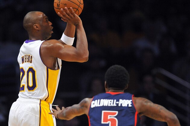 November 17, 2013; Los Angeles, CA, USA; Los Angeles Lakers shooting guard Jodie Meeks (20) shoots a basket against the defense of Detroit Pistons shooting guard Kentavious Caldwell-Pope (5) during the first half at Staples Center. Mandatory Credit: Gary A. Vasquez-USA TODAY Sports