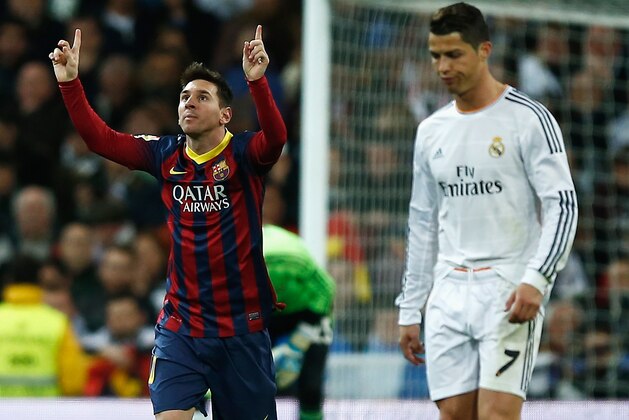 MADRID, SPAIN - MARCH 23:  Lionel Messi of Barcelona celebrates scoring his team's third goal as Cristiano Ronaldo of Real Madrid looks dejected during the La Liga match between Real Madrid CF and FC Barcelona at the Bernabeu on March 23, 2014 in Madrid, Spain.  (Photo by Gonzalo Arroyo Moreno/Getty Images)