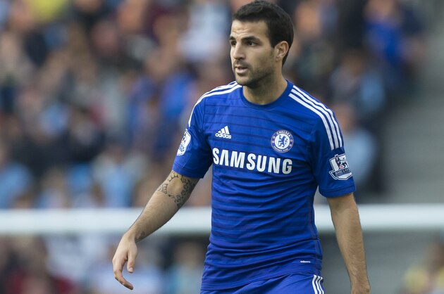 Chelsea's Cesc Fabregas takes the ball downfield during his team's English Premier League soccer match against Manchester City at the Etihad Stadium, Manchester, England, Sunday Sept. 21, 2014. (AP Photo/Jon Super)