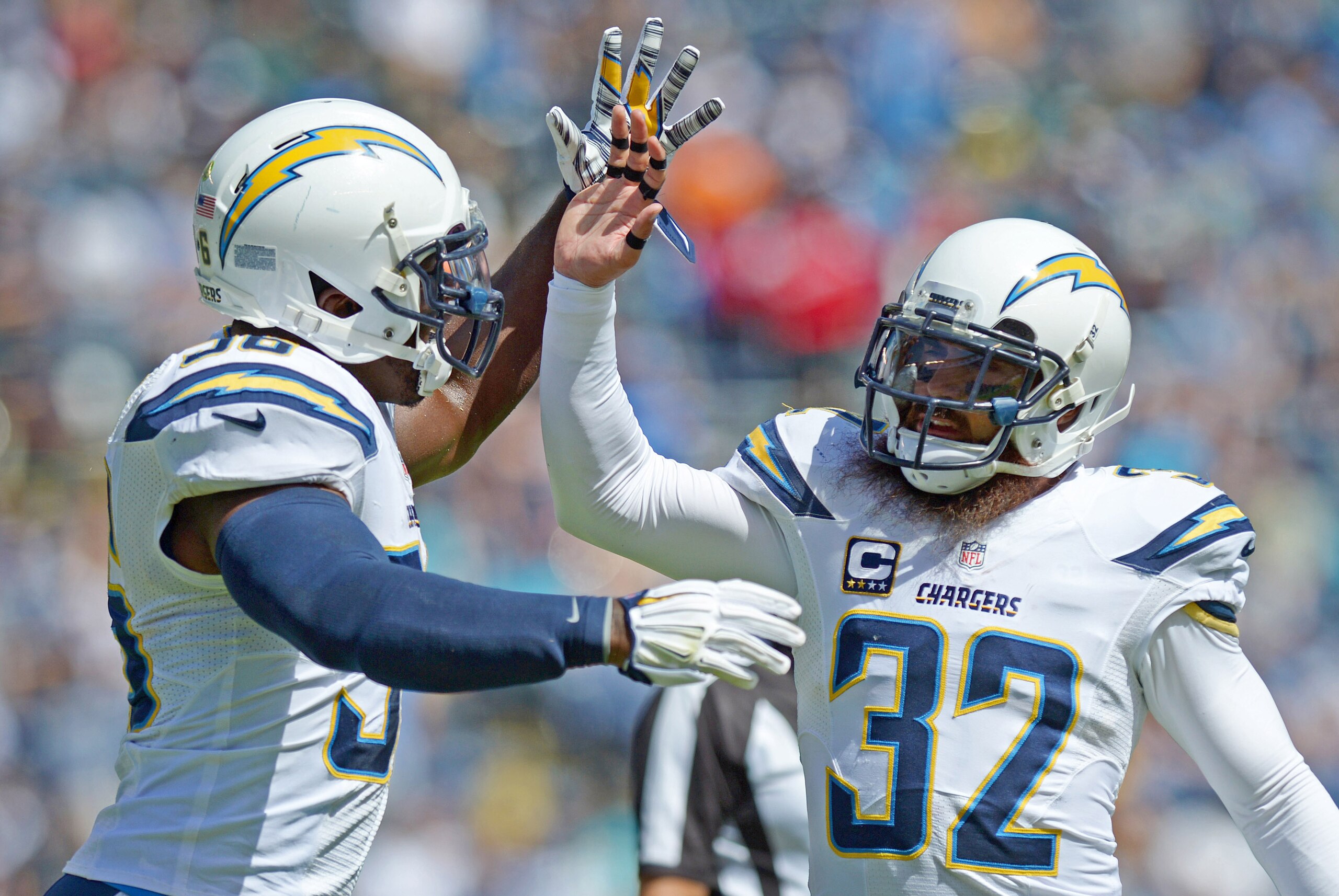 Sep 28, 2014; San Diego, CA, USA; San Diego Chargers free safety Eric Weddle (32) celebrates with inside linebacker Donald Butler (56) after the recovered a fumble during the first quarter against the Jacksonville Jaguars at Qualcomm Stadium. Mandatory Credit: Jake Roth-USA TODAY Sports