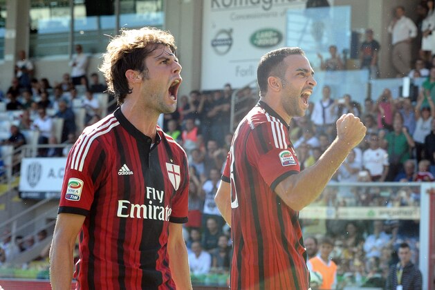 CESENA, ITALY - SEPTEMBER 28:  Adil Rami # 13 of AC Milan ( R ) celebrates with his teamate Andrea Poli # 16 of AC Milan ( L ) after scoring his team's first goal during the Serie A match between AC Cesena and AC Milan at Dino Manuzzi Stadium on September 28, 2014 in Cesena, Italy.  (Photo by Mario Carlini / Iguana Press/Getty Images)