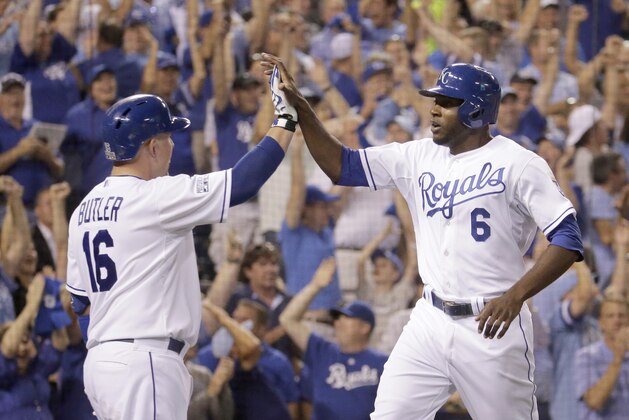 Kansas City Royals' Lorenzo Cain (6) and Billy Butler (16) celebrate after Cain scored on a single by Eric Hosmer during the third inning of the AL wild-card playoff baseball game against the Oakland Athletics Tuesday, Sept. 30, 2014, in Kansas City, Mo. (AP Photo/Charlie Riedel)