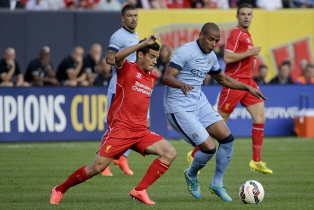 Liverpool midfielder Philippe Coutinho (10), left, challenges Manchester City midfielder Fernando (6) in the first half of a Guinness International Champions Cup soccer tournament match, Wednesday, July 30, 2014, at Yankee Stadium in New York. (AP Photo/Julie Jacobson)