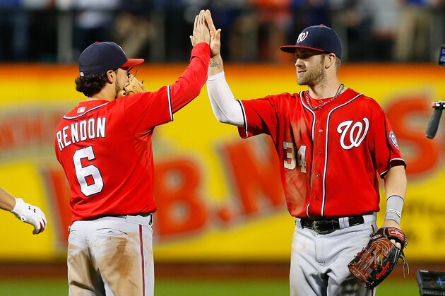 NEW YORK, NY - SEPTEMBER 13:  Bryce Harper #34 and Anthony Rendon #6 of the Washington Nationals celebrate after defeating the New York Mets at Citi Field on September 13, 2014 in the Flushing neighborhood of the Queens borough of New York City.  (Photo by Jim McIsaac/Getty Images)