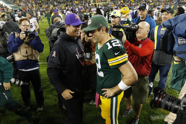 Minnesota Vikings head coach Mike Zimmer and Green Bay Packers' Aaron Rodgers after an NFL football game Thursday, Oct. 2, 2014, in Green Bay, Wis. The Packers won 42-10. (AP Photo/Mike Roemer)