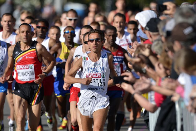 Italy's Ruggero Pertile leads the pack during the men's marathon in the old town of Zurich, Switzerland, during the European Athletics Championships on Sunday, Aug. 17, 2014. (AP Photo/Martin Meissner)