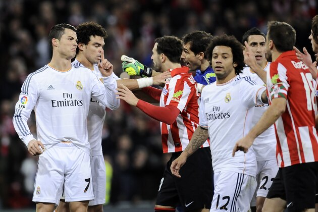 Real Madrid's Cristiano Ronaldo of Portugal, left, reacts with Athletic Bilbao's players during their Spanish League soccer match against Athletic Bilbao, at San Mames stadium in Bilbao, Spain, Sunday, Feb. 2, 2014.  (AP Photo/Alvaro Barrientos)