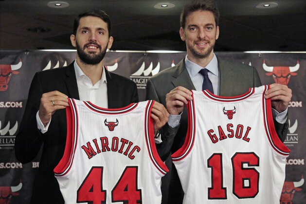 The Chicago Bulls newest acquisitions, forward Nikola Mirotic, left, and free agent forward/center Pau Gasol pose with their jerseys at a an NBA news conference Friday, July 18, 2014, in Chicago. The Bulls are hoping the new additions will help bolster their offensive attack after they struggled to score at times last year. Mirotic was acquired by Chicago on June 24, 2011, as part of a draft-night trade with the Minnesota Timberwolves and played last with Spain's Real Madrid CF. Gasol a 13-year veteran of the NBA, comes to Chicago after spending the past six-plus seasons with the Los Angeles Lakers. (AP Photo/M. Spencer Green)