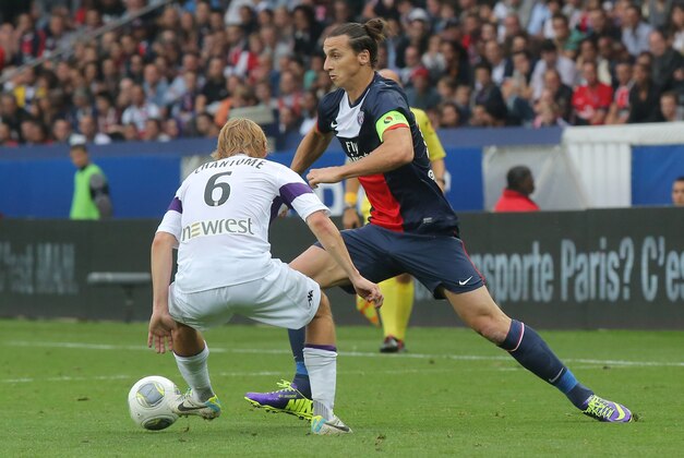 Paris Saint-Germain's Swedish Zlatan Ibrahimovic, right, vies for the ball, past Toulouse's Clement Chantome during a French League One soccer match Paris Saint-Germain against FC Toulouse at Parc des Princes stadium in Paris, Saturday, Sept. 28, 2013. Paris Saint-Germain won 2-0. (AP Photo/Michel Euler)
