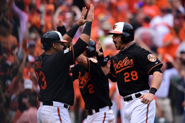 BALTIMORE, MD - OCTOBER 03: J.J. Hardy #2 celebrates with his teammates Nelson Cruz #23 and Steve Pearce #28 after sliding safe to home plate to score the go ahead run on Delmon Young #27 of the Baltimore Orioles three run RBI double to deep left feild in the eighth inning against Joakim Soria #38 of the Detroit Tigers during Game Two of the American League Division Series at Oriole Park at Camden Yards on October 3, 2014 in Baltimore, Maryland. (Photo by Patrick Smith/Getty Images) BALTIMORE, MD - OCTOBER 03: J.J. Hardy #2 celebrates with his teammates Nelson Cruz #23 and Steve Pearce #28 after sliding safe to home plate to score the go ahead run on Delmon Young #27 of the Baltimore Orioles three run RBI double to deep left feild in the eighth inning against Joakim Soria #38 of the Detroit Tigers during Game Two of the American League Division Series at Oriole Park at Camden Yards on October 3, 2014 in Baltimore, Maryland. (Photo by Patrick Smith/Getty Images)