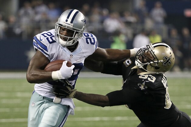 Dallas Cowboys running back DeMarco Murray (29) fights off a tackle attempt by New Orleans Saints' Junior Galette (93)during the second half of an NFL football game, Sunday, Sept. 28, 2014, in Arlington, Texas. (AP Photo/Brandon Wade)