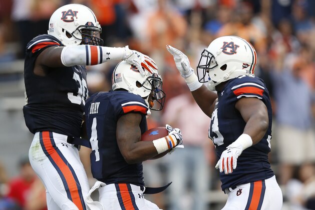 Auburn wide receiver Quan Bray (4) celebrates with his teammates Auburn running back Damian Lewis (30) and Auburn wide receiver B.J. Trimble (33) into the end zone with a smile as he scores a touchdown against Louisiana Tech during the second half of an NCAA college football game on Saturday, Sept. 27, 2014, in Auburn, Ala.(AP Photo/Brynn Anderson)